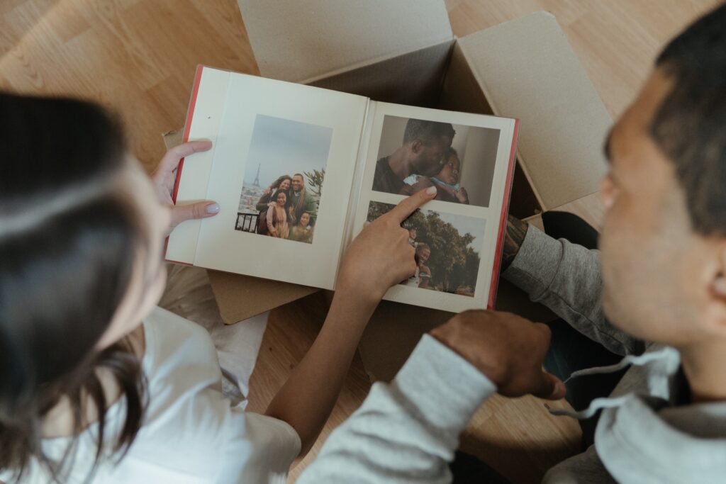 Photo Book Ideas: A Guide To Different Types of Photo Books You Can Create | Image of a couple looking at a photo album together